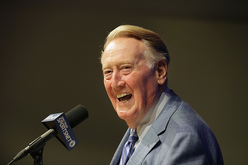 In this Sept. 24, 2016 file photo, Los Angeles Dodgers broadcaster Vin Scully, who is retiring after the season, smiles as he answers questions from the media during a news conference at Dodger Stadium in Los Angeles. President Barack Obama is honoring Scully, Cicely Tyson, Tom Hanks, Michael Jordan and others with the Presidential Medal of Freedom, the nation's highest civilian honor. (AP Photo/Jae C. Hong, File)