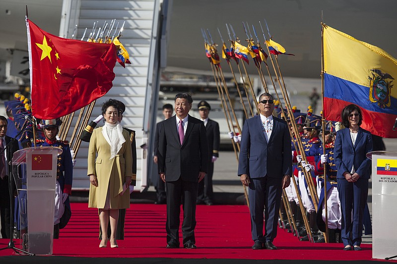 
              China's President Xi Jinping, center, and his wife Peng Liyuan stand with Ecuador's President Rafael Correa, second from right, during a welcoming ceremony at Mariscal Sucre Airport in Quito, Ecuador, Thursday, Nov. 17, 2016. Xi Jinping is in Ecuador for two days before heading to Peru for the APEC summit. (AP Photo/Ana Buitron)
            