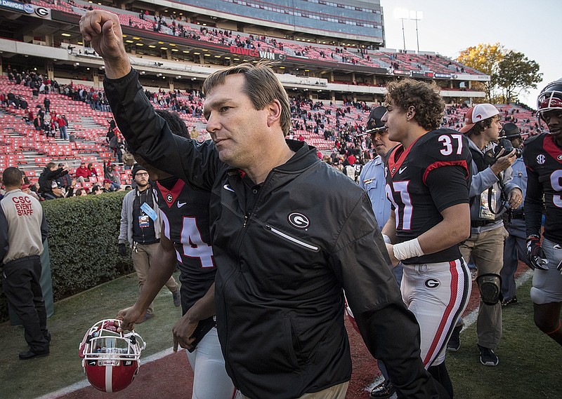 First-year Georgia head coach Kirby Smart walks off the field after the black-jerseyed Bulldogs' 35-21 home win over Louisiana-Lafayette.