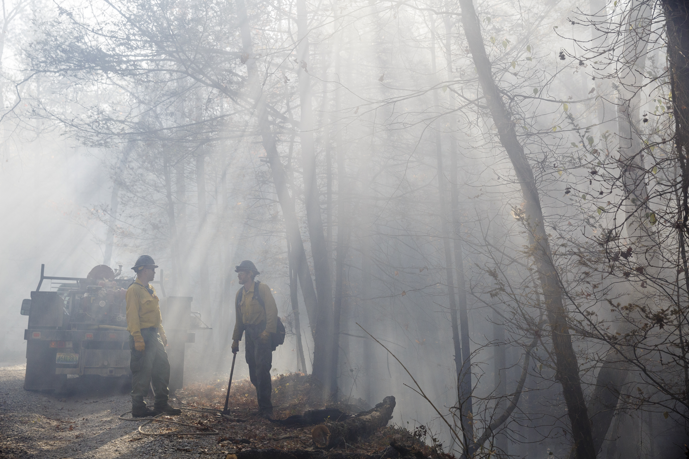 Firefighters Nate Huestis, left, and Devin Delaney with the Kansas Bureau of Indian Affairs stand in thick smoke near their engine while battling the Rough Ridge wildfire in the Cohutta Wilderness of the Chattahoochee-Oconee National Forest on Friday, Nov. 18, 2016, near Chatsworth, Ga. The wildfire, which was started by lightning in mid-October, has burned in mostly wilderness areas.
