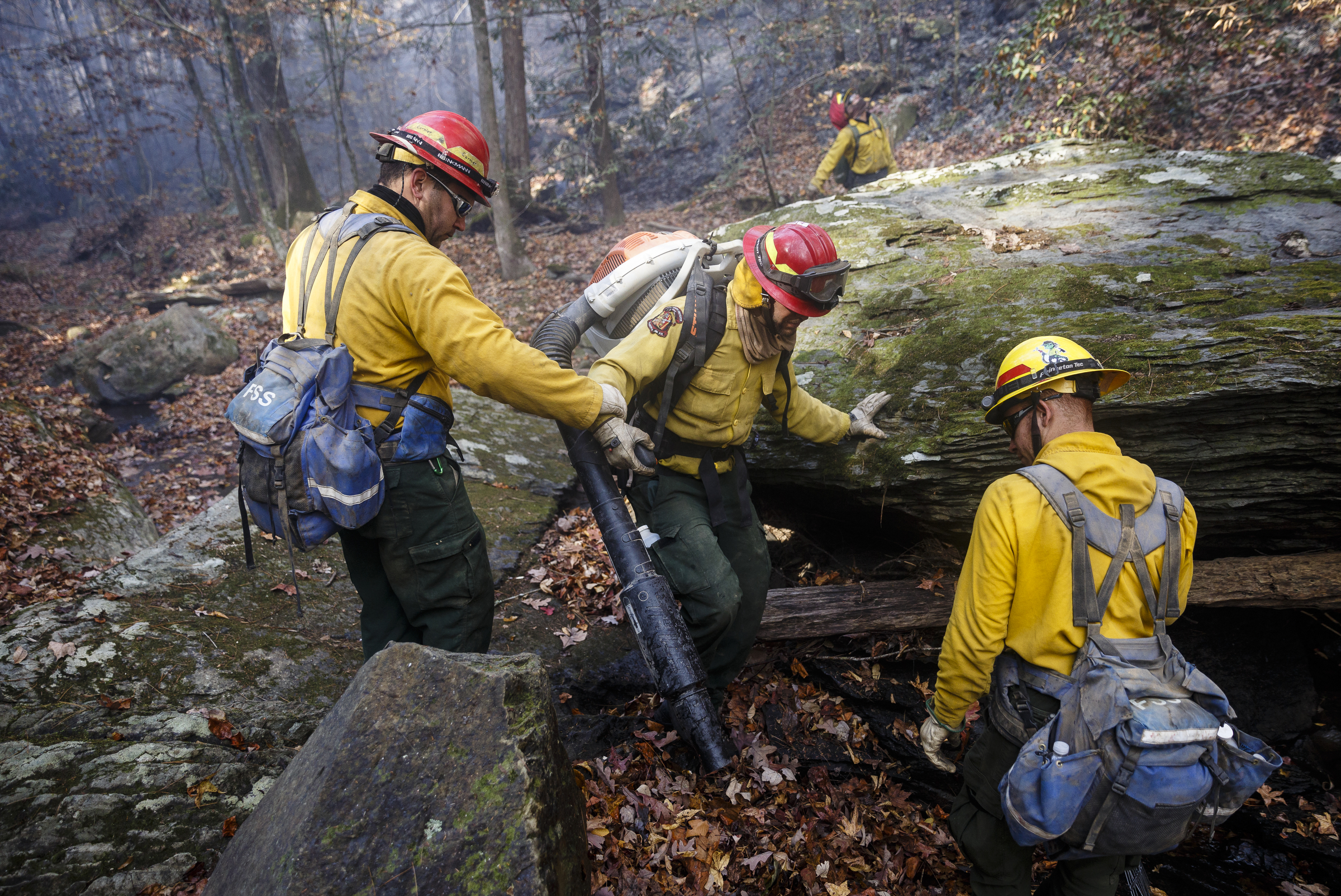 Firefighters with a team from Puerto Rico navigate difficult terrain while battling the Rough Ridge wildfire in the Cohutta Wilderness of the Chattahoochee-Oconee National Forest on Friday, Nov. 18, 2016, near Chatsworth, Ga. The wildfire, which was started by lightning in mid-October, has burned in mostly wilderness areas.