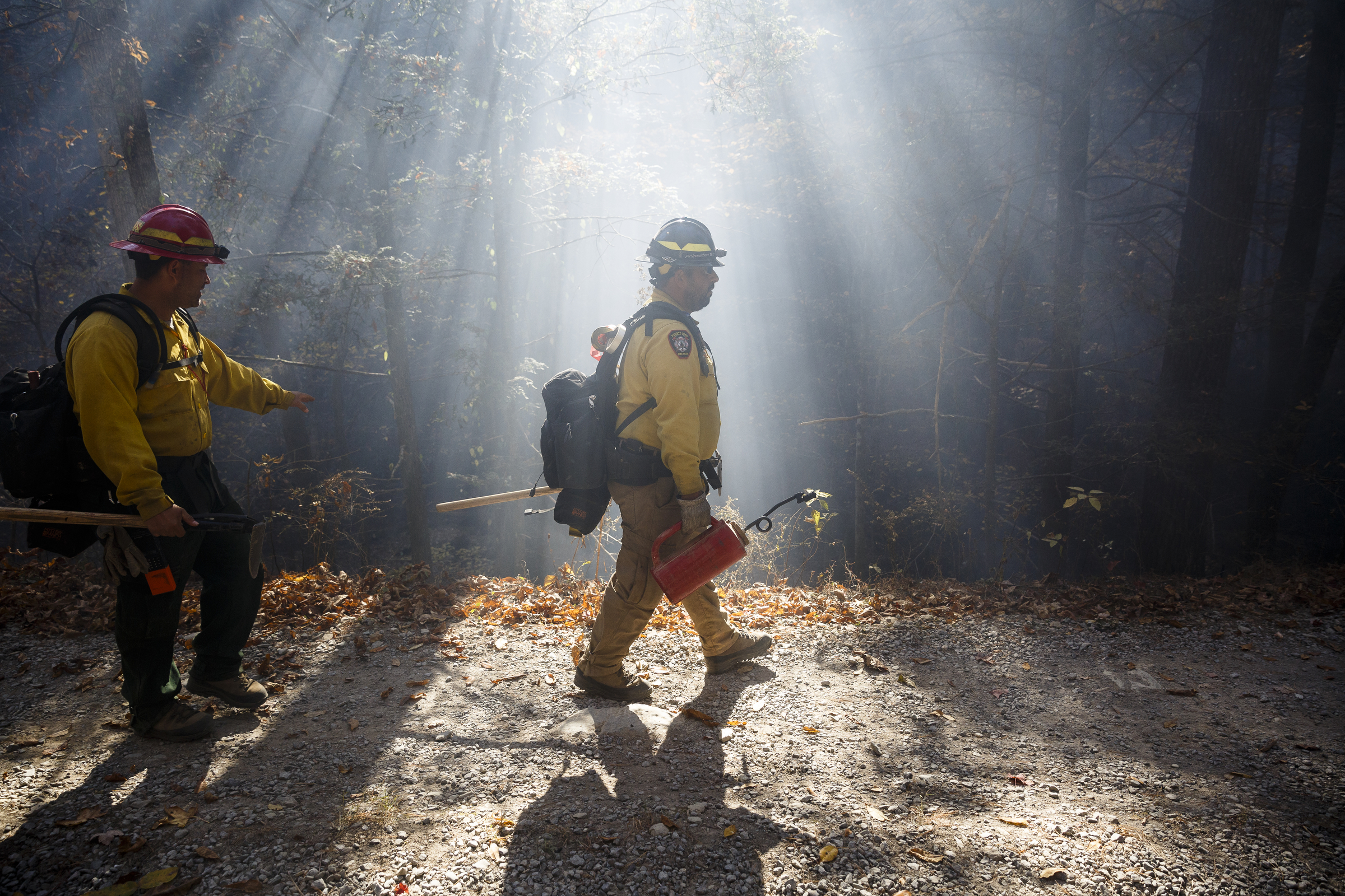 Firefighters, Luis Saez, left, and Jose Martinez from Puerto Rico prepare to light a burnout to deprive the fire of fuel while battling the Rough Ridge wildfire in the Cohutta Wilderness of the Chattahoochee-Oconee National Forest on Friday, Nov. 18, 2016, near Chatsworth, Ga. The wildfire, which was started by lightning in mid-October, has burned in mostly wilderness areas.