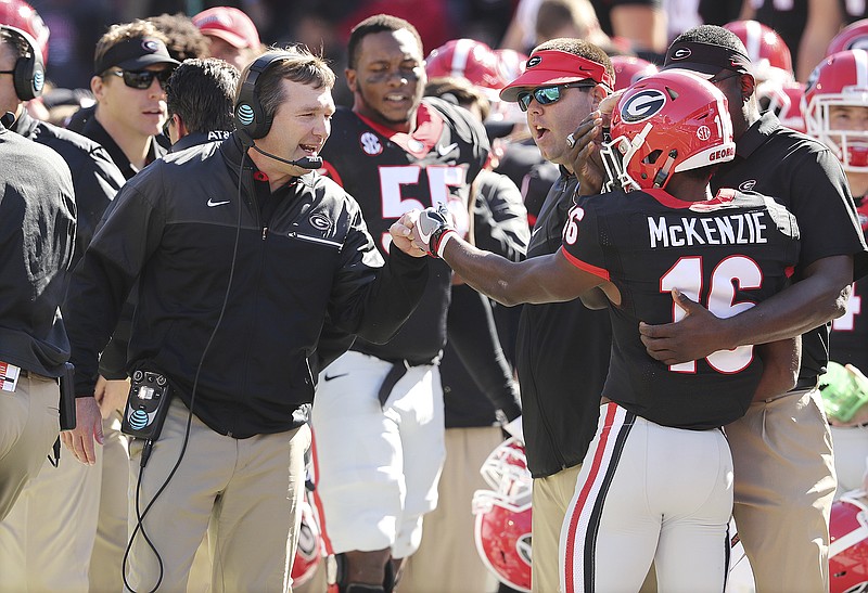 Georgia wide receiver Isaiah McKenzie gets a fist bump from head coach Kirby Smart after returning a punt against Louisiana-LaFayette for a touchdown during the first quarter in an NCAA college football game on Saturday, Nov. 19, 2016, in Athens. (Curtis Compton/Atlanta Journal-Constitution via AP)