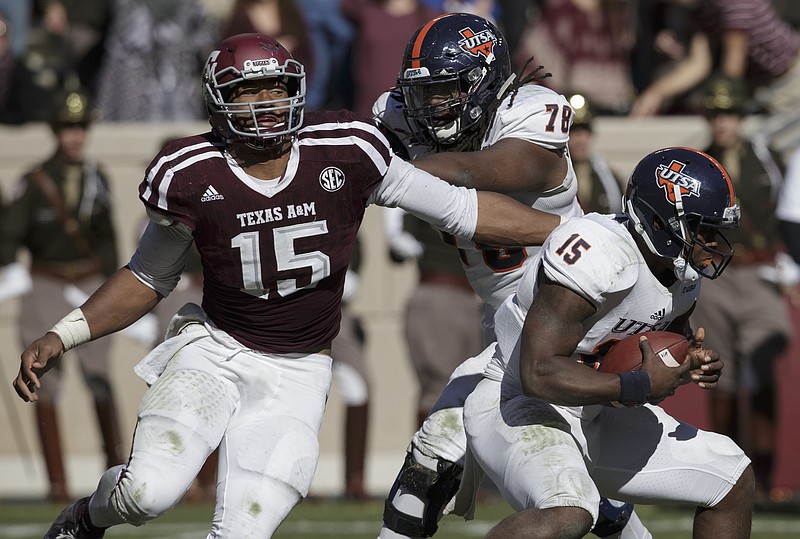 Texas A&M defensive lineman Myles Garrett (15) makes a one-handed sack as he pulls down UTSA quarterback Jared Johnson (15) during the third quarter of an NCAA college football game Saturday, Nov. 19, 2016, in College Station, Texas. (AP Photo/Sam Craft)

