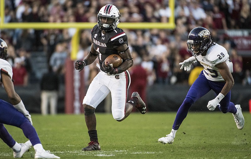 South Carolina wide receiver Deebo Samuel (1) picks up yardage against Western Carolina defensive back Marvin Tillman (29) during the first half of an NCAA college football game Saturday, Nov. 19, 2016, in Columbia, S.C. (AP Photo/Sean Rayford)