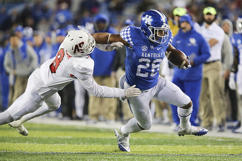 Kentucky running back Benny Snell Jr. gets past the tackle of Austin Peay defensive back Trent Taylor to score a touchdown in the first half of an NCAA college football game Saturday, Nov. 19, 2016, in Lexington, Ky. (AP Photo/David Stephenson)