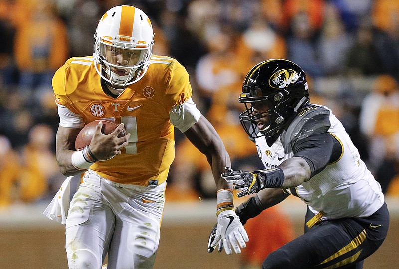 Tennessee senior quarterback Joshua Dobbs runs past Missouri safety Brock Bondurant during Saturday's 63-37 win in Knoxville. The Vols are 8-3 and have this week's regular-season finale at Vanderbilt and a bowl game to reach 10 wins for the first time since the 2007 season.