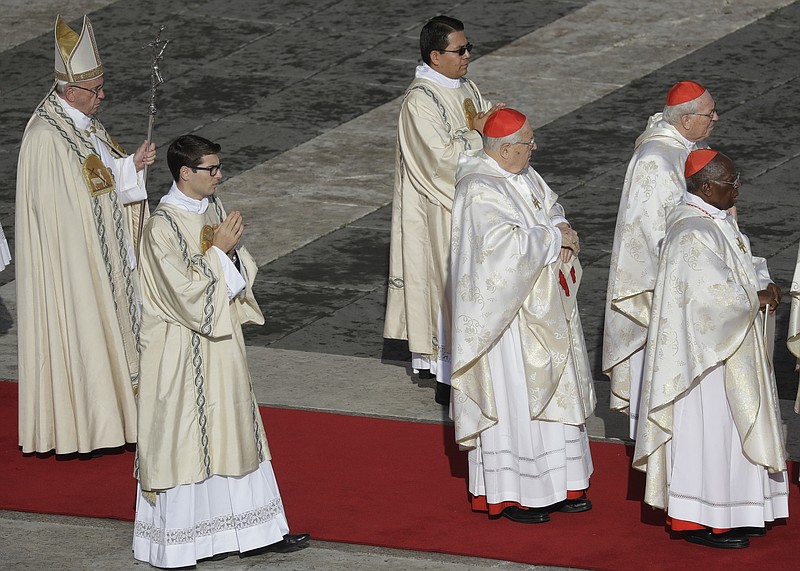 
              Pope Francis, left, arrives for a Mass on the occasion of the closing of the Holy Door of St. Peter's Basilica at the Vatican, Sunday, Nov. 20, 2016. The Holy Door closing marks the end of the Jubilee of Mercy. (AP Photo/Gregorio Borgia)
            