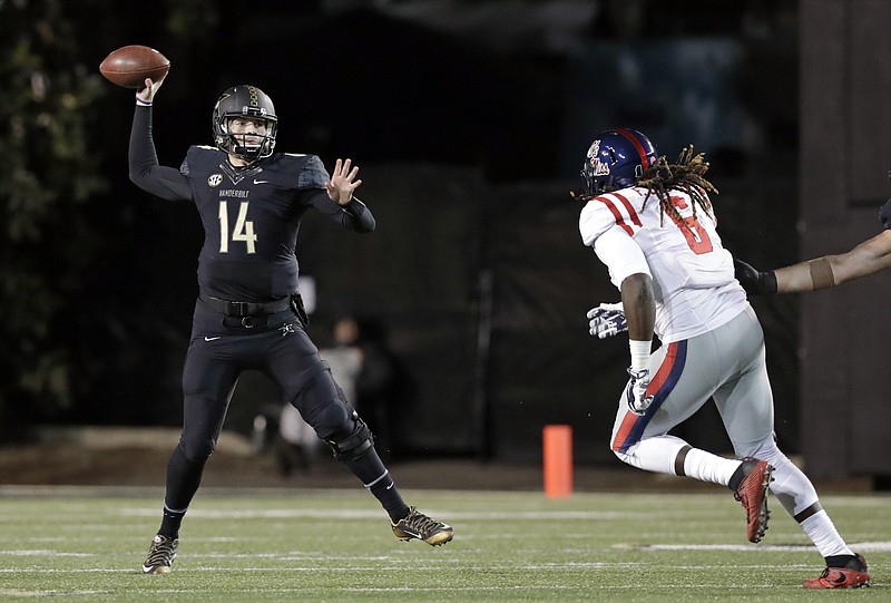 Vanderbilt quarterback Kyle Shurmur (14) passes as he is pressured by Mississippi defensive end Fadol Brown (6) in the first half of an NCAA college football game Saturday, Nov. 19, 2016, in Nashville, Tenn. (AP Photo/Mark Humphrey)