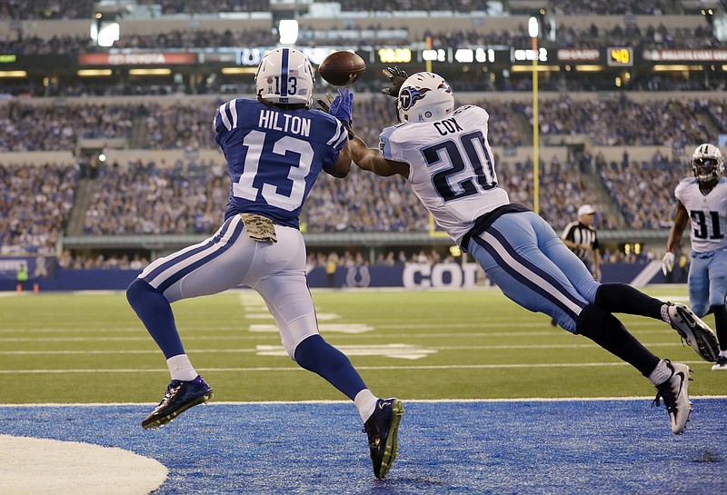 Indianapolis Colts wide receiver T.Y. Hilton (13) makes a catch for a touchdown over Tennessee Titans cornerback Perrish Cox (20) during the first half of an NFL football game in Indianapolis, Sunday, Nov. 20, 2016. (AP Photo/Jeff Roberson)

