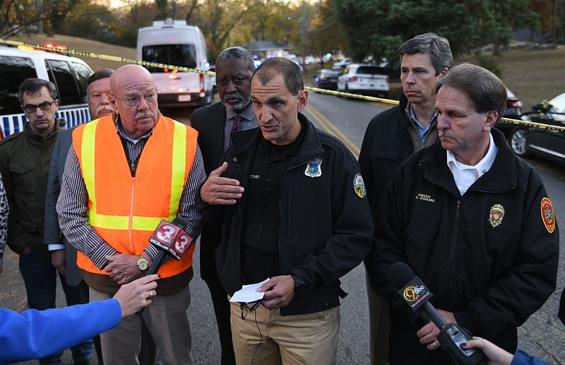 Chattanooga police chief Fred Fletcher, center, talks with the press at the scene of a school bus wreck involving multiple fatalities on Talley Road in Chattanooga, Tenn., Monday, Nov. 21, 2016. Others, from left, Hamilton County District Attorney Neal Pinkston, Hamilton County Mayor Jim Coppinger, Hamilton County Emergency Medical Services director Ken Wilkerson, interim superintendent of Hamilton County Schools, Kirk Kelly, Chattanooga Mayor Andy Berke and Fire Chief Chris Adams also listen.