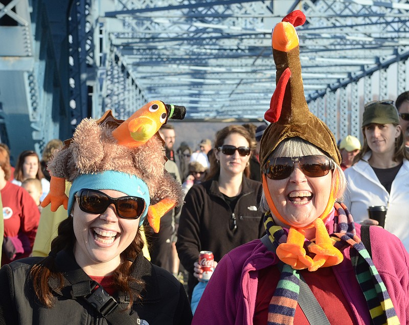 Festive attire is welcome at the various Thanksgiving Day runs. Vanessa Draeger, left, and Gerry Kirk opted for turkey hats at a previous Grateful Gobbler Walk through downtown Chattanooga.