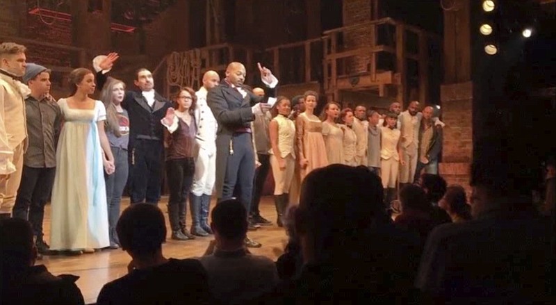 In this image made from a video provided by Hamilton LLC, actor Brandon Victor Dixon who plays Aaron Burr, the nation's third vice president, in "Hamilton" speaks from the stage after the curtain call in New York on Friday. Vice President-elect Mike Pence is the latest celebrity to attend the Broadway hit "Hamilton," but the first to get a plea from the stage. (Hamilton LLC via AP)