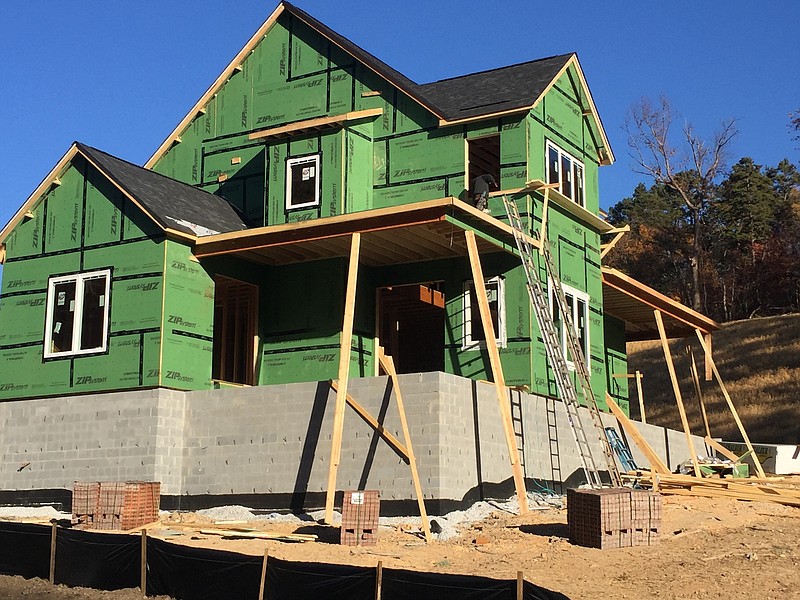 Home builders continue work on one of the new houses being built by Green Tech Homes in the new Northshore Heights subdivision off of Dartmouth Street. The first couple of homes in the 77-home subdivision are nearing completion.