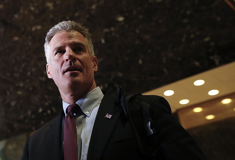 Former Massachusetts Sen. Scott Brown talks with media at Trump Tower, Monday, Nov. 21, 2016 in New York. AP Photo/Carolyn Kaster)