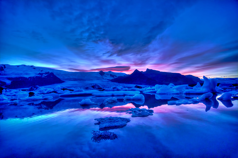 Iceland's northern shore is populated with massive icebergs the size of city buses drifting lazily in the ocean.