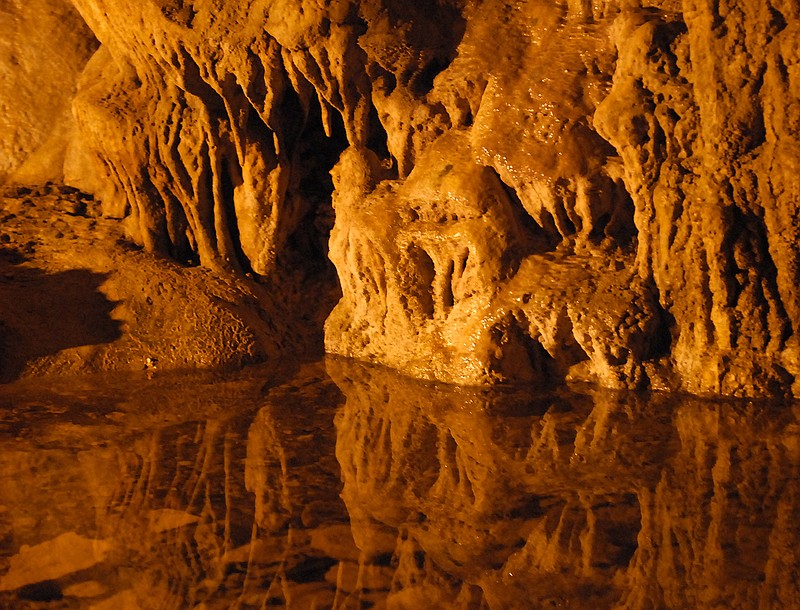Stalagmites and stalactites, the calcium carbonate formations that decorate many limestone caves, are formed by water dripping into the cave.

