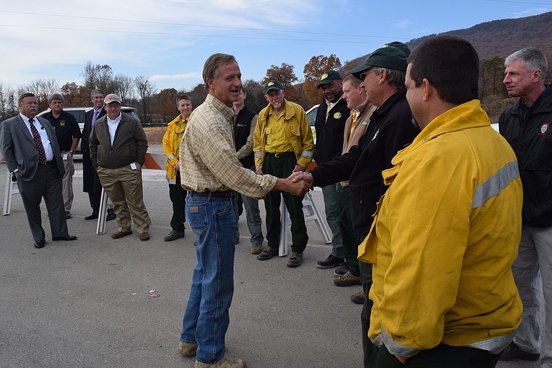 Tennessee Governor Bill Hallam greets state and local officials at the Hamilton County wildfire command post in Soddy Daisy on Wednesday. Hallam thanked Tennessee Division of Forestry firefighters and Department of Agriculture officials for their efforts to battle brush fires across the region.