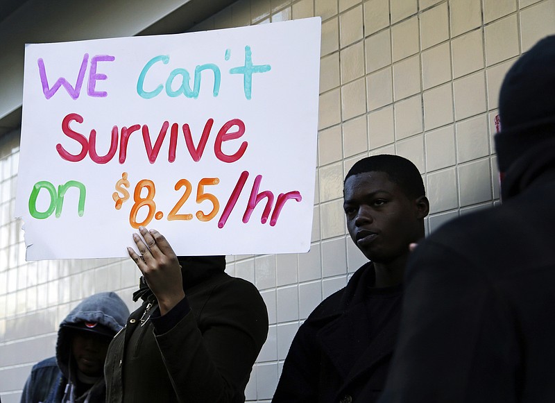 FILE - In this Thursday, Dec. 5, 2013, file photo, protestors demonstrate outside a McDonald's restaurant in Oakland, Calif. A federal court on Tuesday, Nov. 22, 2016, blocked implementation of a rule imposed by President Barack Obama's administration that would have made an estimated 4 million more higher-earning workers across the country eligible for overtime pay starting Dec. 1, 2016. The U.S. District Court in the Eastern District of Texas granted the nationwide preliminary injunction that prevents the Department of Labor from implementing the changes while the regulation's legality is examined in more detail by the court. (AP Photo/Ben Margot, File)