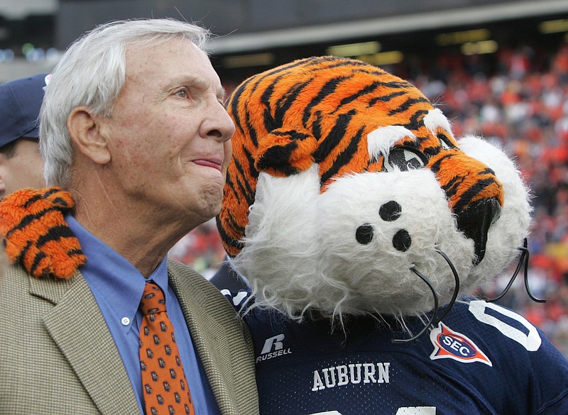 Former Auburn coach Pat Dye watches with Auburn's mascot a video tribute to his career before the start of the Iron Bowl against Alabama, Saturday Nov. 19, 2005 in Auburn, Ala. The school re-named the playing field after him. (AP Photo/Jamie Martin)
