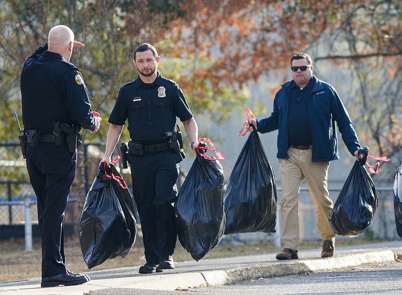 Volunteers arrive with bags of items to put in care packages for students at Woodmore Elementary School on Wednesday, Nov. 23, 2016, in Chattanooga, Tenn. Students at the school were victims in a school bus crash that killed 6 children and injured dozens more.