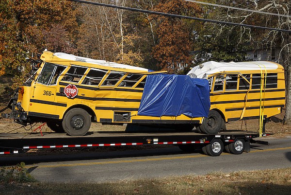 A wrecker removes the school bus from the scene of a crash on Talley Road on Tuesday, Nov. 22, 2016, in Chattanooga, Tenn. The Monday afternoon crash killed at least 5 elementary schoolchildren and injured dozens more. The NTSB has been called in to help investigate.