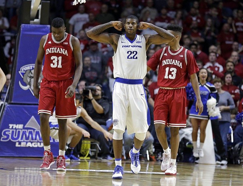 
              IPFW forward Xzavier Taylor (22) celebrates as he walk in front of Indiana centers Thomas Bryant (31) and Juwan Morgan (13) during overtime of an NCAA college basketball game in Fort Wayne, Ind., Tuesday, Nov. 22, 2016. IPFW defeated Indiana 71-68. (AP Photo/Michael Conroy)
            