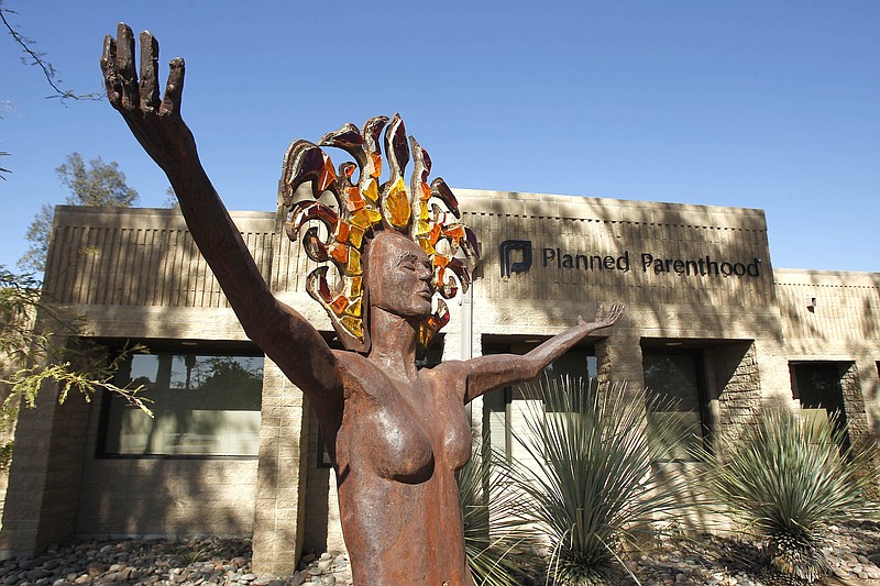 
              FILE - In this Jan. 23, 2011 file photo, a statue representing women's empowerment stands in front of a Planned Parenthood facility in Tucson, Ariz. The number and rate of abortions tallied by federal authorities have fallen to their lowest level in decades, according to new data released Wednesday, Nov. 23, 2016.   (AP Photo/Ross D. Franklin, File)
            