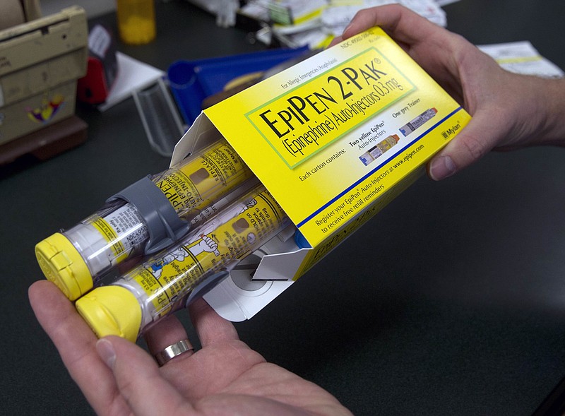 
              FILE - In this July 8, 2016, file photo, a pharmacist holds a package of EpiPen epinephrine auto-injectors, a Mylan product, in Sacramento, Calif. The chairman of the Senate Judiciary Committee said Wednesday, Nov. 23, 2016, he is considering a subpoena or another method of compelling testimony from the pharmaceutical company Mylan, the Justice Department and the federal Centers for Medicare and Medicaid Services. All three parties have refused to attend a committee hearing next week. (AP Photo/Rich Pedroncelli, File)
            
