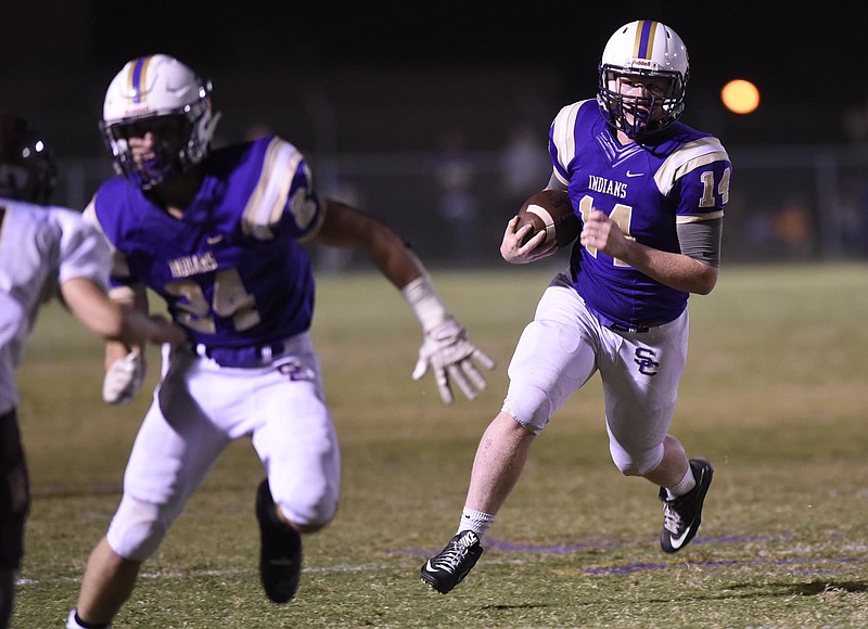 Sequatchie County quarterback Ethan Barker (14) follows the blocking of Austin Stephens (24).  The Cannon County Lions visited the Sequatchie County Indians  in TSSAA football action on October 14, 2016