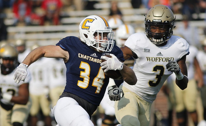 UTC runningback Derrick Craine rushes around Woffard safety JoJo Tillery during the Mocs' home football game against the Wofford Terriers at Finely Stadium on Saturday, Nov. 12, 2016, in Chattanooga, Tenn.