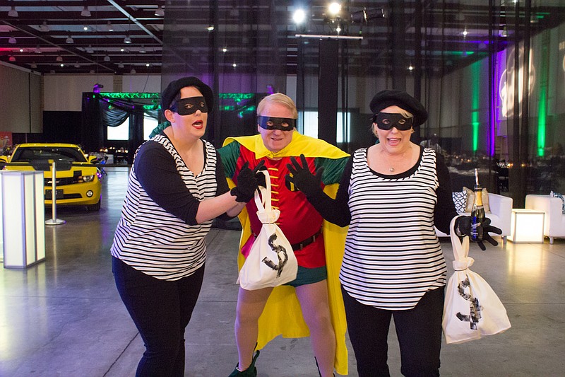 Gene Lovin, dressed as Robin the Boy Wonder, with his daughter Christina Morgan, right, and his granddaughter, Taylor Morgan, left. This photo was taken only seconds before Gene collapsed from a massive heart attack. (Courtesy of Holt Webb Photography)