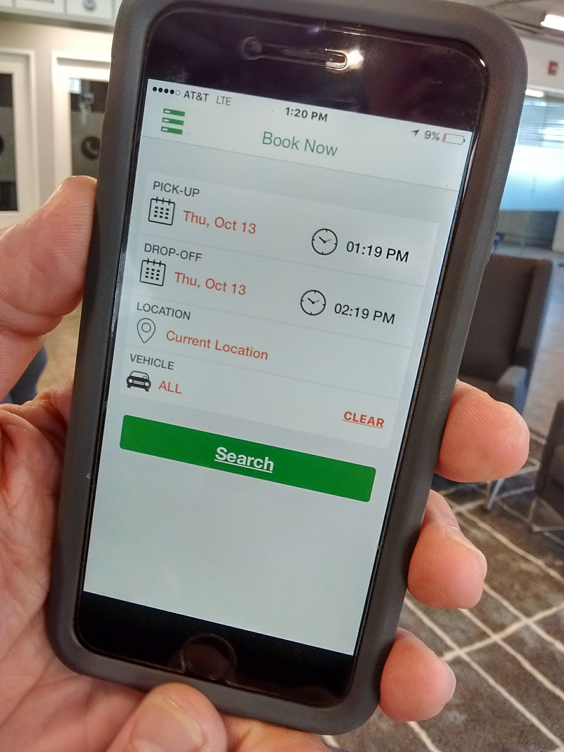 Longtime Chattanooga electric car advocate Jim Frierson shows the smartphone app used to find and unlock Green Commuter Chattanooga's $9-an-hour Nissan Leafs.