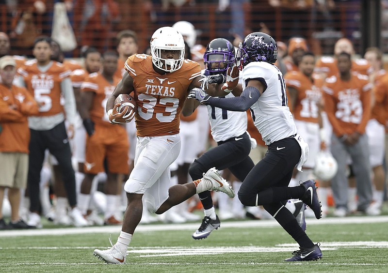 
              Texas running back D'Onta Foreman (33) is pursued by TCU safety Nick Orr (18) on a 44-yard carry during the second half of an NCAA college football game, Friday, Nov. 25, 2016, in Austin, Texas. (AP Photo/Eric Gay)
            