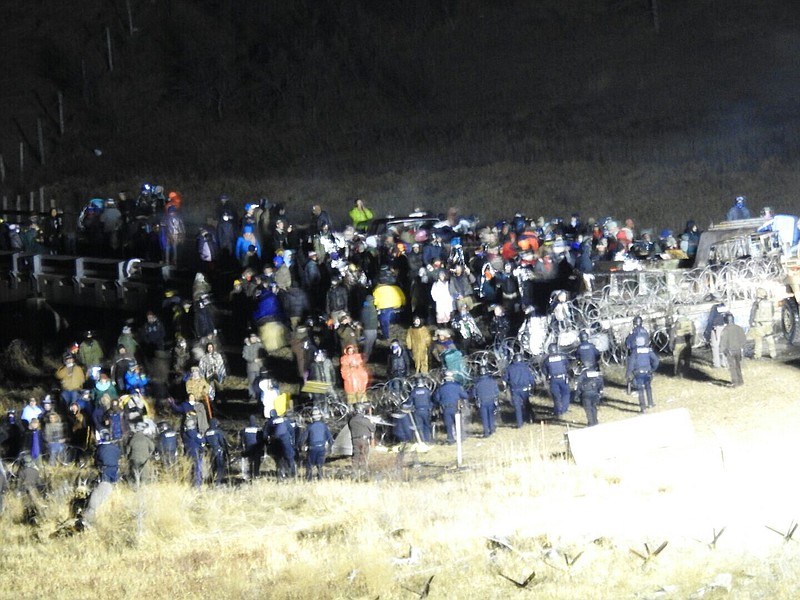 In this image provided by Morton County Sheriff's Department, law enforcement and protesters clash near the site of the Dakota Access pipeline on Sunday, Nov. 20, 2016, in Cannon Ball, N.D. The clash came as protesters sought to push past a bridge on a state highway that had been blockaded since late October, according to the Morton County Sheriff's Office. (Morton County Sheriff's Department via AP)

