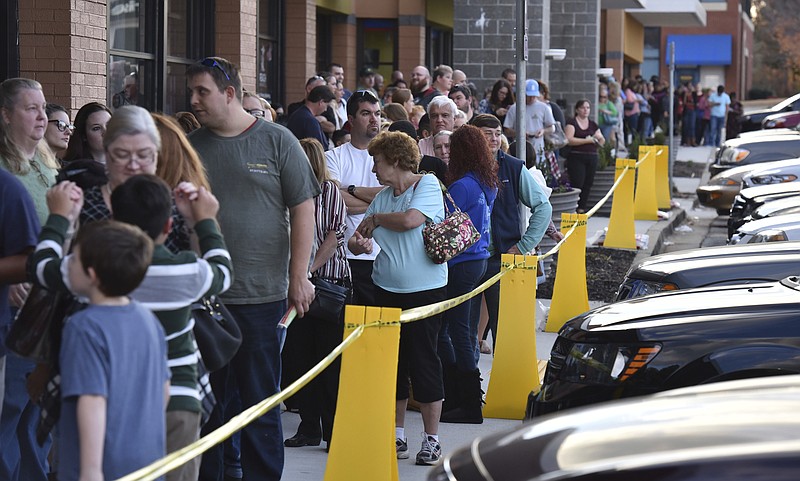 Early Black Friday shoppers stand in line to check out at Toys R Us - Town Center on Thanksgiving night Thursday, Nov. 24, 2016, in Kennesaw, Ga.