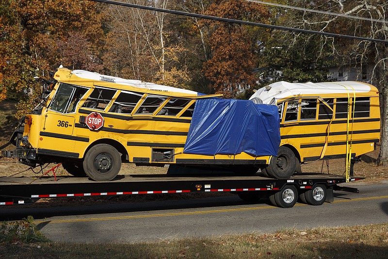 A wrecker removes the school bus from the scene of the Talley Road crash. The National Transportation Safety Board is investigating the crash.