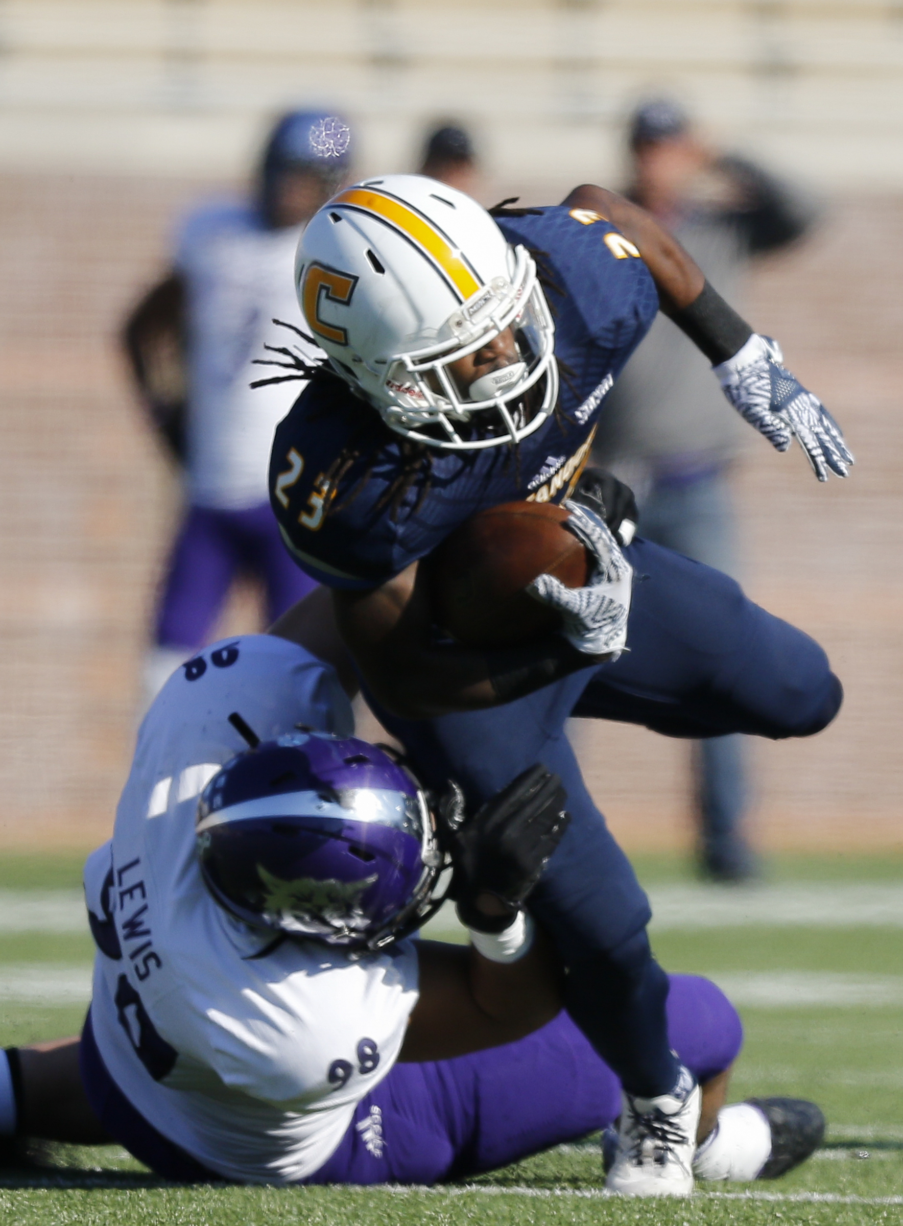 Weber State defensive end Adam Lewis tackles UTC running back Richardre Bagley during the Mocs' first-round FCS football playoff game against Weber State at Finely Stadium on Saturday, Nov. 26, 2016, in Chattanooga, Tenn. UTC won 45-14.