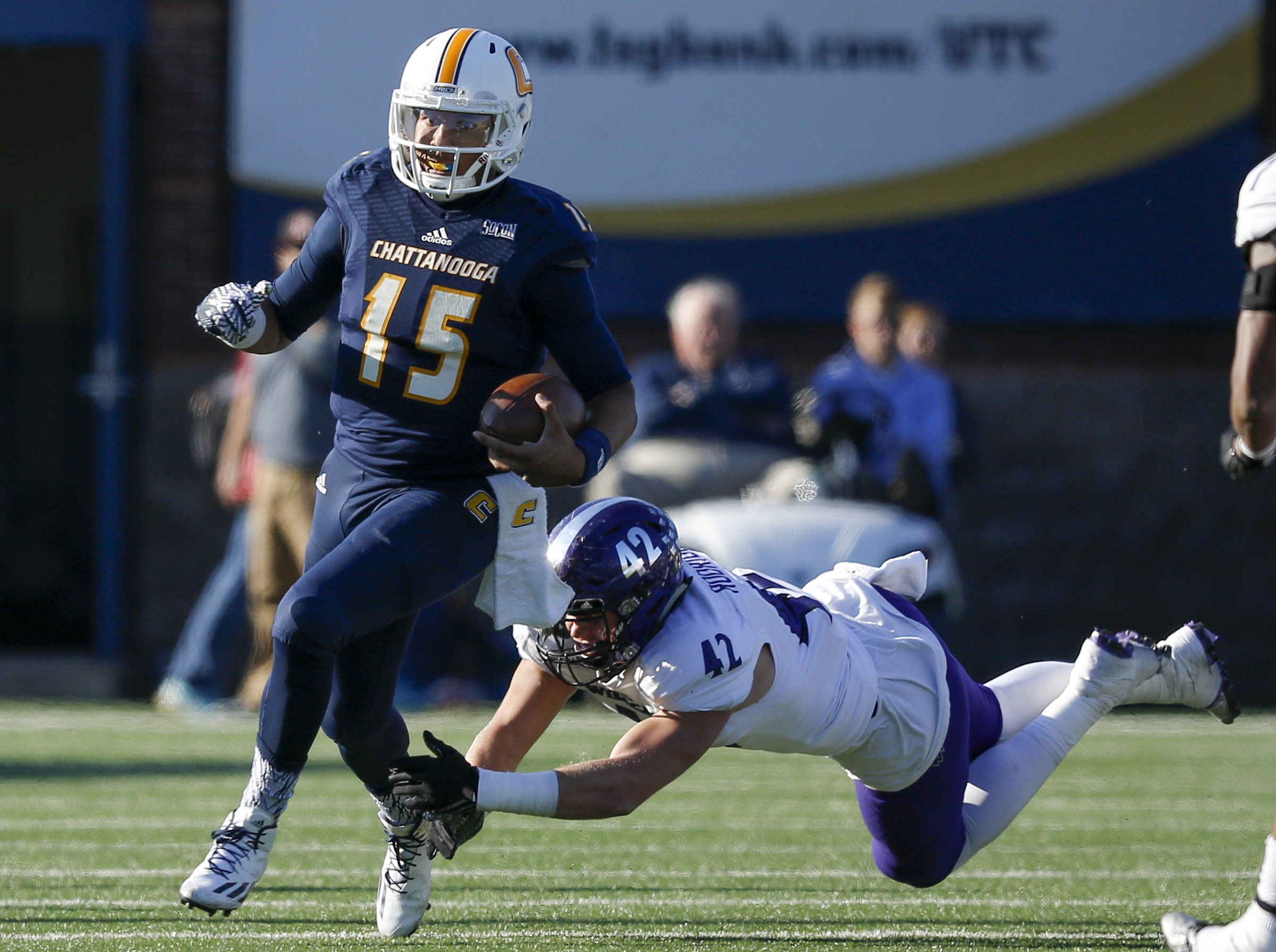 UTC quarterback Alejandro Bennifield breaks a tackle by Weber State defensive lineman Adam Rodriguez during the Mocs' first-round FCS football playoff game against Weber State at Finely Stadium on Saturday, Nov. 26, 2016, in Chattanooga, Tenn. UTC won 45-14.