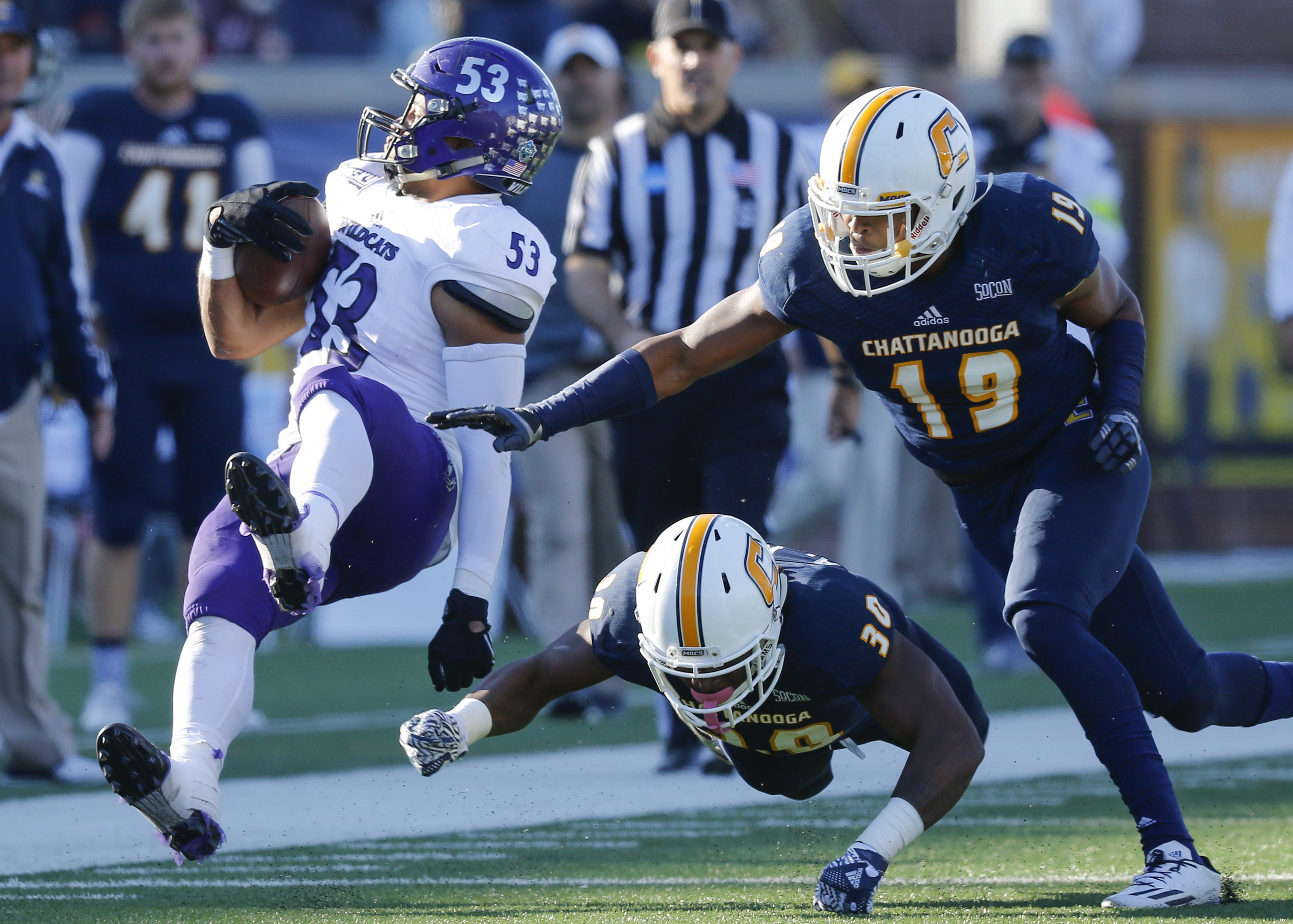 UTC defensive backs Tae Davis (19) and Adrian King (30) tackle Weber State's Auston Tesch during the Mocs' first-round FCS football playoff game against Weber State at Finely Stadium on Saturday, Nov. 26, 2016, in Chattanooga, Tenn. UTC won 45-14.