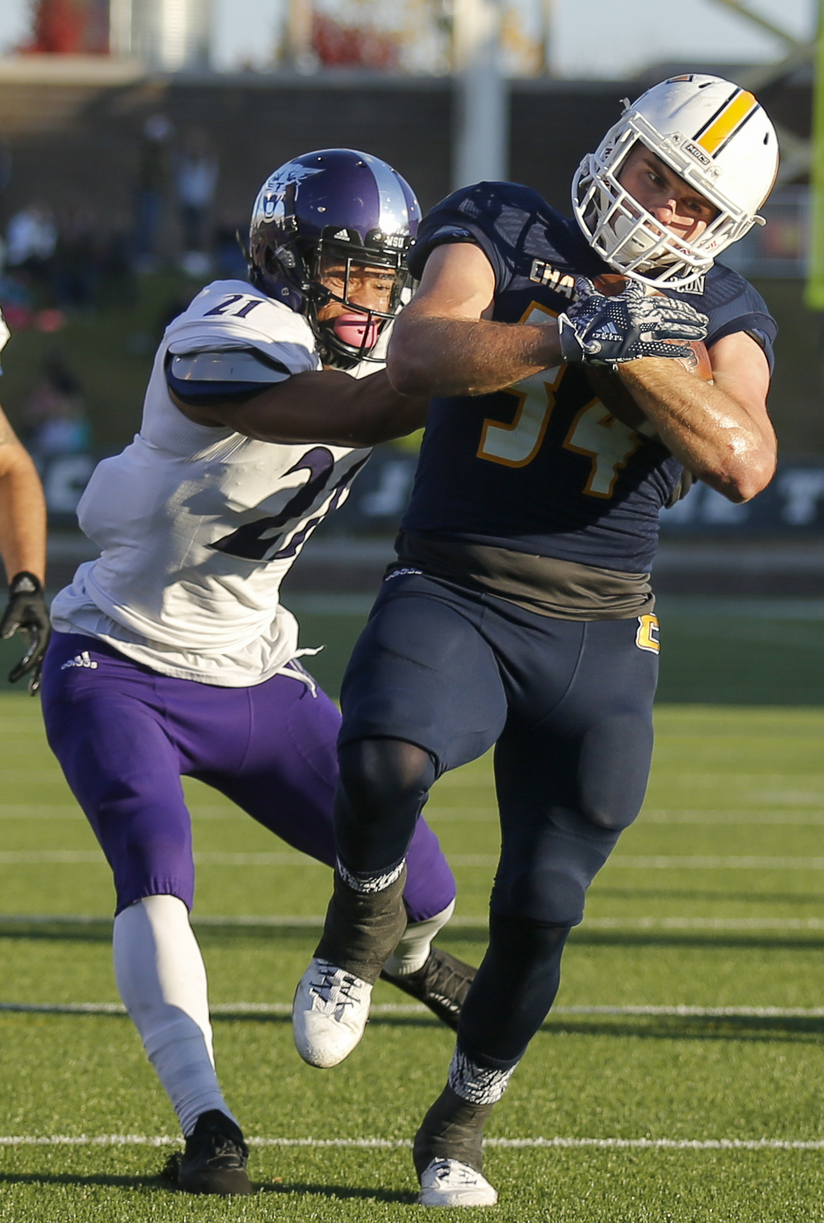 Weber State cornerback Taron Johnson, left, grabs UTC running back Derrick Craine too late to stop a touchdown during the Mocs' 45-14 victory Saturday at Finley Stadium in the first round of the FCS national playoffs.