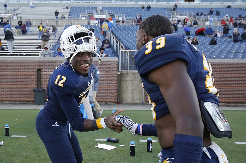 UTC wide receiver Xavier Borishade (12) and defensive back Jordan Jones shake hands after their win in the Mocs' first-round FCS football playoff game against Weber State at Finely Stadium on Saturday, Nov. 26, 2016, in Chattanooga, Tenn. UTC won 45-14.