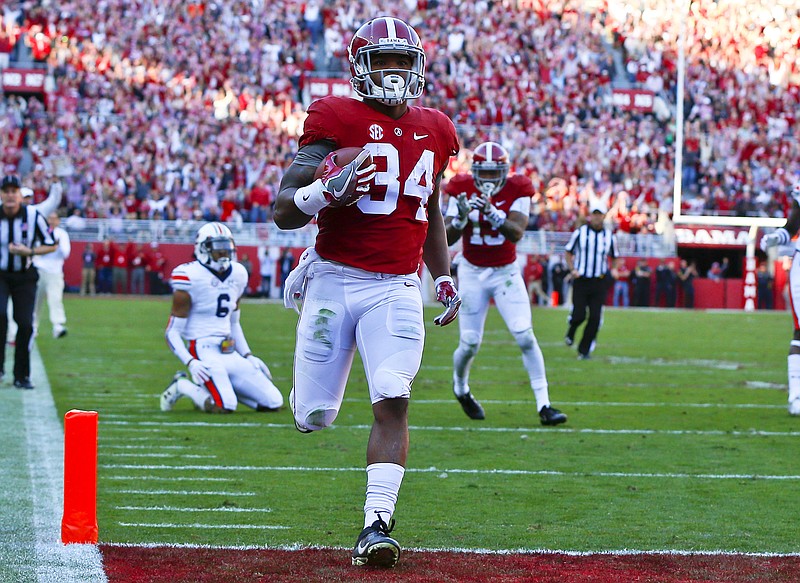 Alabama running back Damien Harris runs in for a touchdown during the first half of an NCAA college football game against Auburn, Saturday, Nov. 26, 2016, in Tuscaloosa, Ala. (AP Photo/Butch Dill)