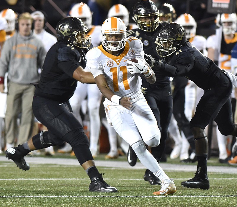 Tennessee quarterback Joshua Dobbs (11) gets past three Vanderbilt defenders for a big gain.  The Tennessee Volunteers visited the Vanderbilt Commodores in a cross-state rivalry at Dudley Stadium on November 26, 2016.  