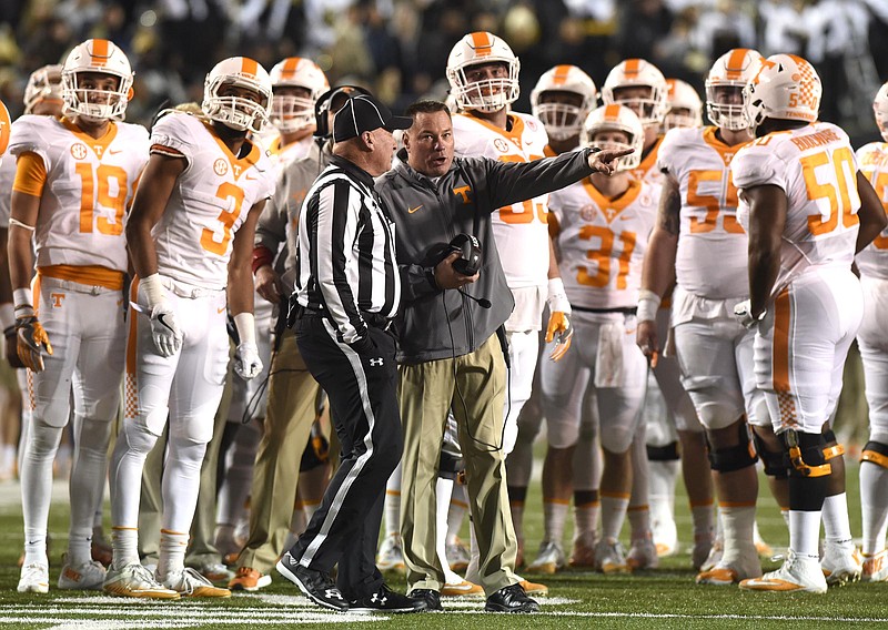 Tennessee football coach Butch Jones talks to an official while the Vols watch a replay of a disputed touchdown during Saturday night's loss at Vanderbilt.