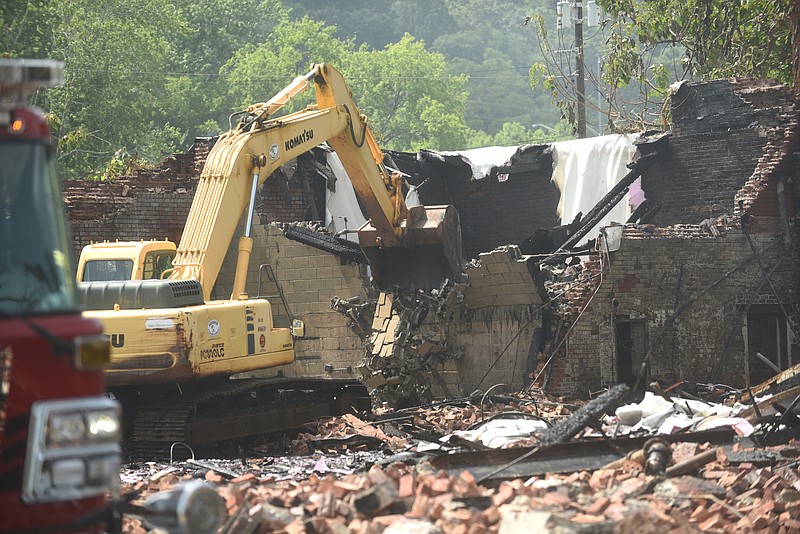 Compromised areas of the old Standard Coosa Thatcher plant are brought down Tuesday, July 12, 2016, after a fire destroyed part of the structure.
