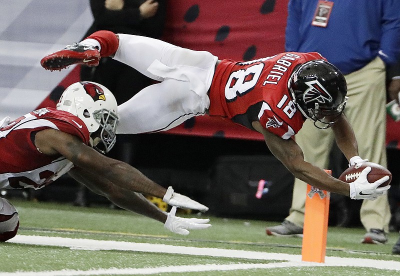 Atlanta Falcons wide receiver Taylor Gabriel (18) leaps into the end zone for a touchdown against Arizona Cardinals strong safety Tony Jefferson (22) during the second of an NFL football game, Sunday, Nov. 27, 2016, in Atlanta. (AP Photo/David Goldman)

