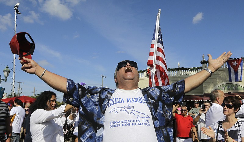 
              A member of the Cuban community celebrates the death of Fidel Castro, Saturday, Nov. 26, 2016, in the Little Havana area in Miami. Castro, who led a rebel army to improbable victory in Cuba, embraced Soviet-style communism and defied the power of 10 U.S. presidents during his half century rule, died at age 90. (AP Photo/Alan Diaz)
            