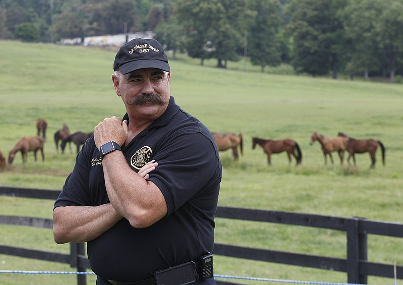 Walker Valley Fire Chief Randy Camp talks to reporters at Happy Valley Farm in Rossville, Ga, in 2013.