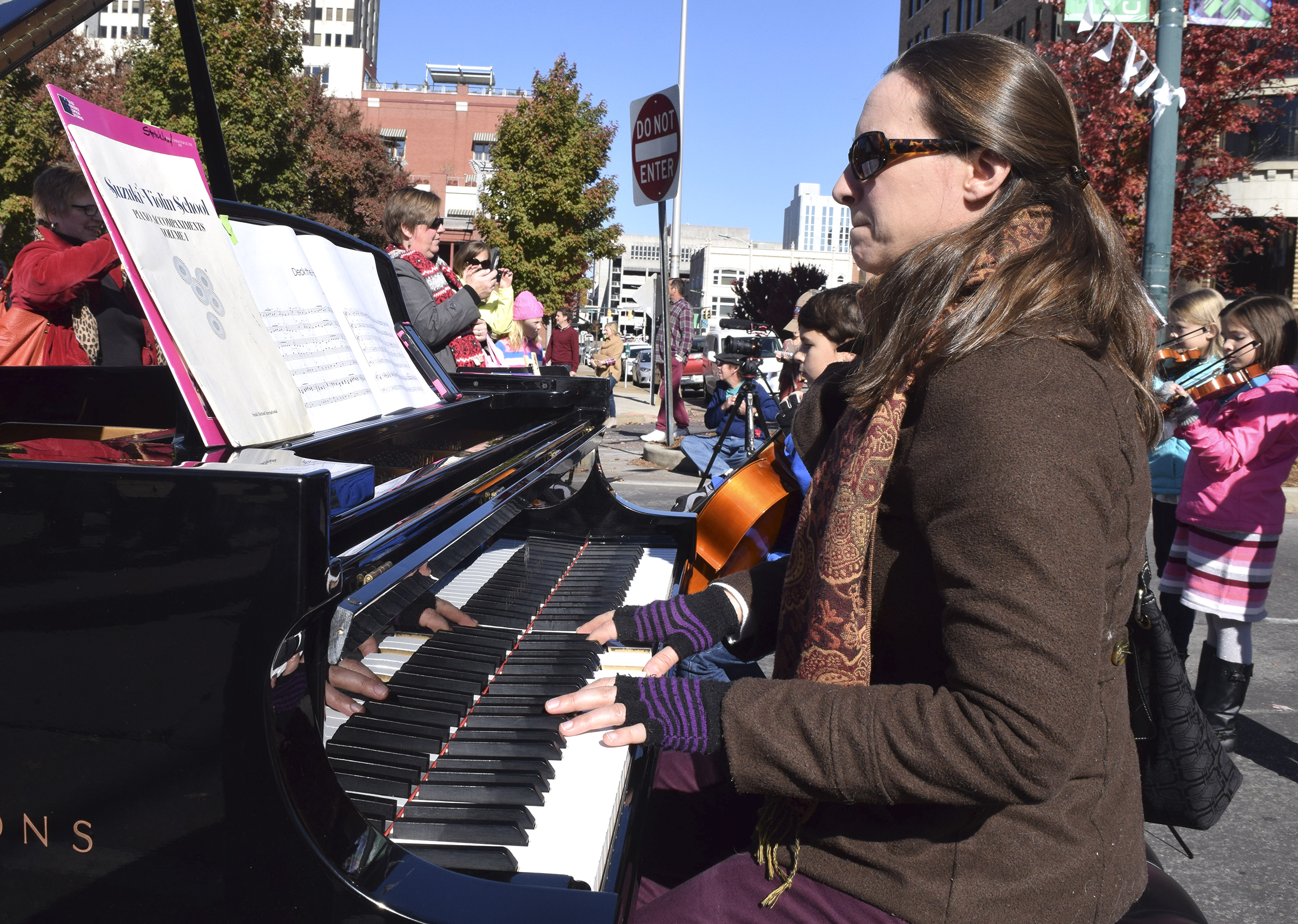 Music teacher Sarah Strickland and her students provide music for the event.